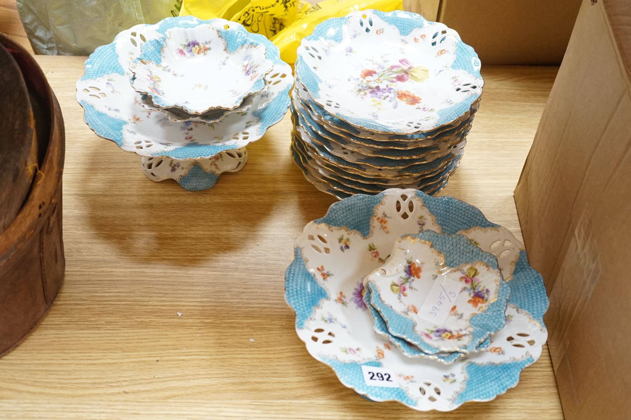 A floral and gilt dessert set, comprising of: 3 comports, 10 plates and 6 assorted dishes.